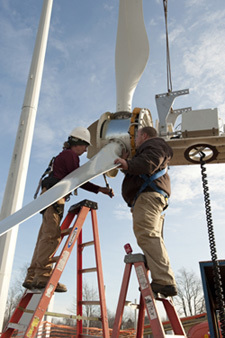 Workers installing wind turbine