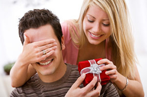 A man and woman exchanging a gift